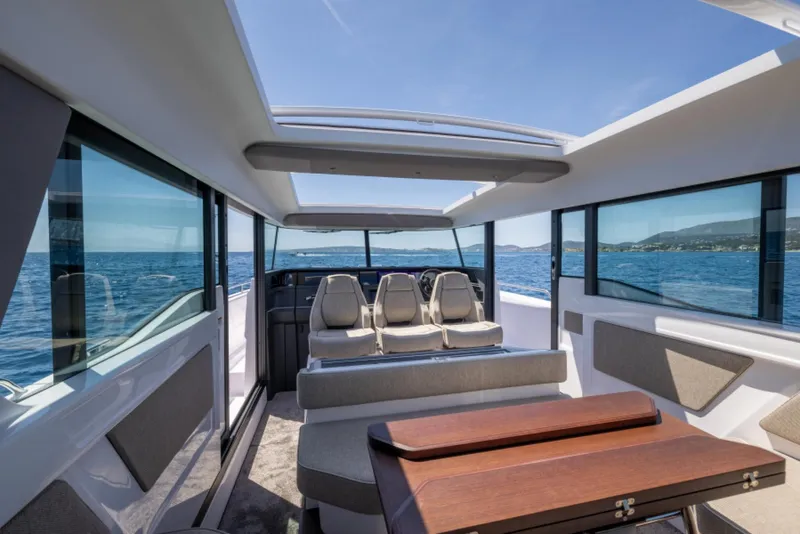 Slide: The Image of Interior of 2024 Axopar 45 boat with panoramic windows and modern seating. - 5