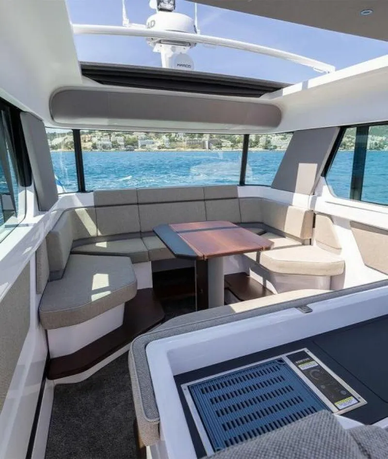 Slide: The Image of 2024 Axopar 45 interior with panoramic windows and modern seating. - 8