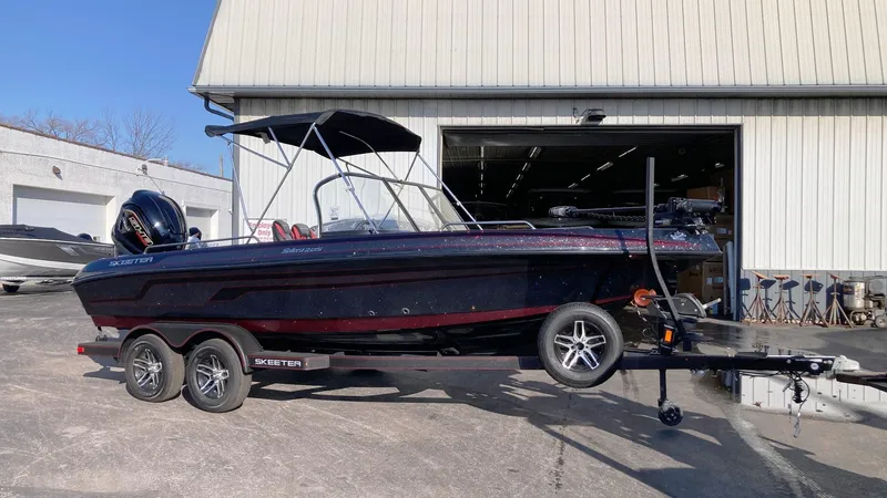 The Image of 2024 Skeeter Solera 205 boat on a trailer outside a warehouse. - 0