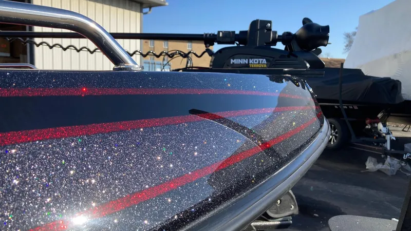 Slide: The Image of 2024 Skeeter Solera 205 boat with glittery black and red detailing. - 2