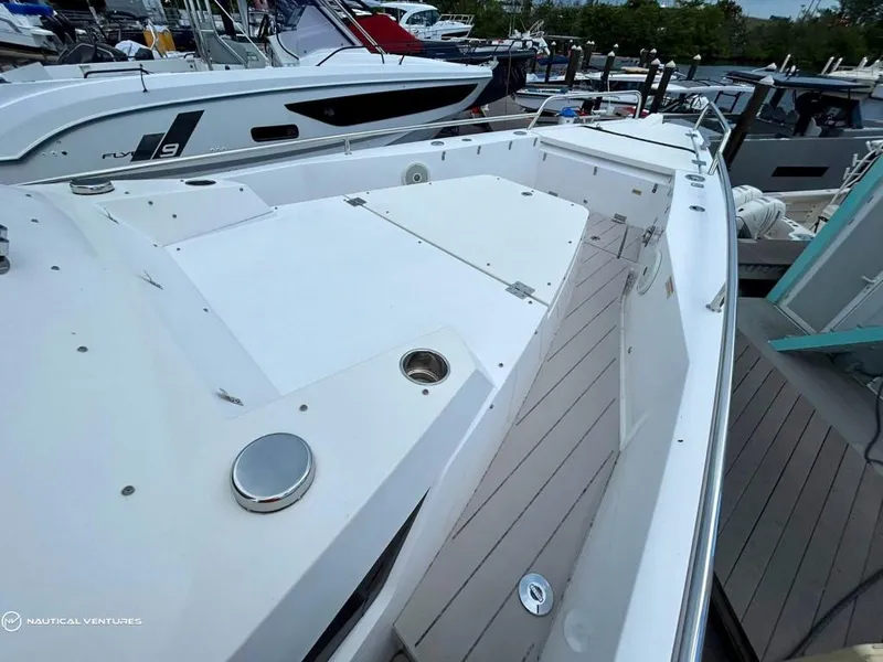 Slide: The Image of 2018 Axopar 37 Sun Top boat docked at marina, showcasing spacious deck. - 10