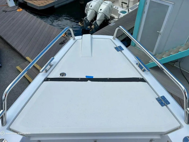 Slide: The Image of 2018 Axopar 37 Sun Top boat bow with stainless steel railings at dock. - 12
