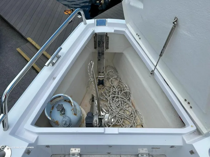 Slide: The Image of Anchor storage compartment of 2018 Axopar 37 Sun Top boat with ropes and anchor. - 13