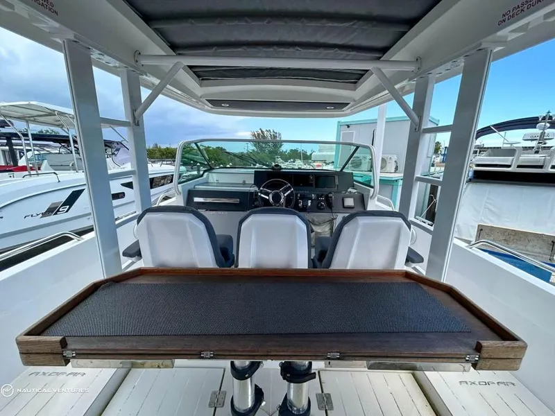 Slide: The Image of 2018 Axopar 37 Sun Top boat interior with helm and seating. - 15