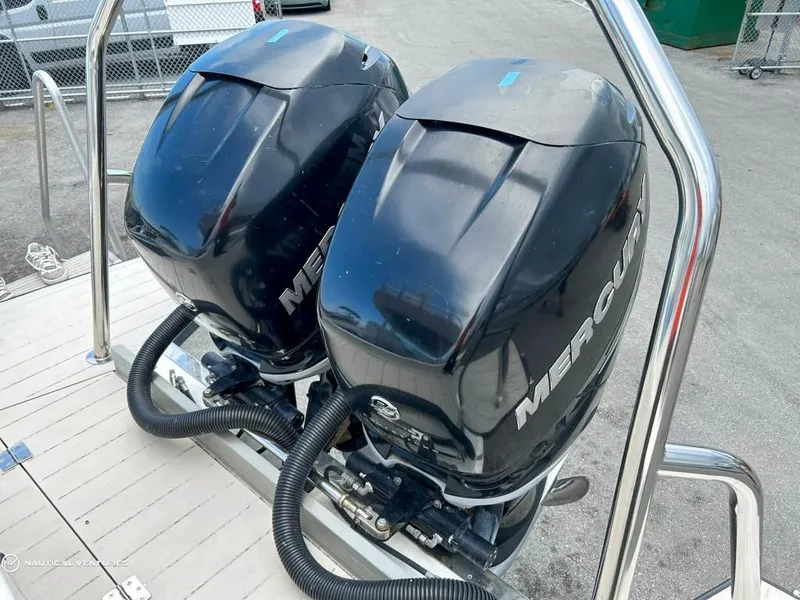Slide: The Image of Twin Mercury outboard engines on a 2018 Axopar 37 Sun Top boat. - 23