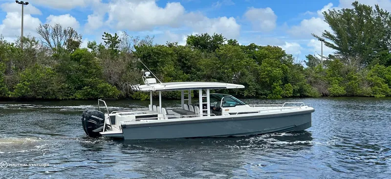 Slide: The Image of 2018 Axopar 37 Sun Top boat cruising on a scenic waterway. - 3