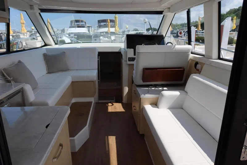 Slide: The Image of Luxurious interior of 2024 Regal 38 Fly yacht with white seating and wood accents. - 14