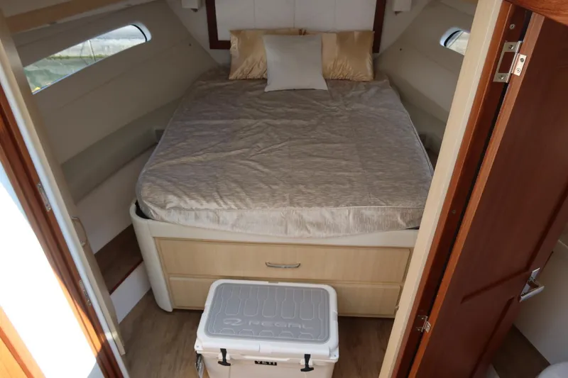 Slide: The Image of Luxurious cabin interior of 2024 Regal 38 Fly yacht with cozy bed and storage. - 15