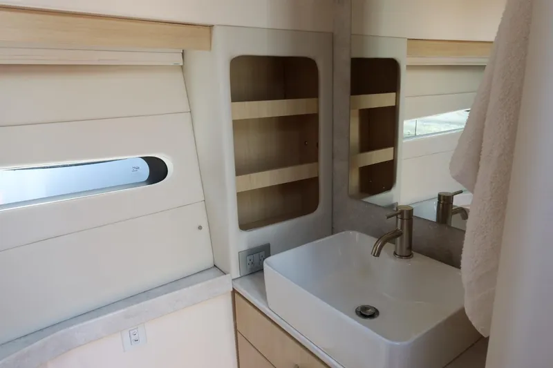 Slide: The Image of 2024 Regal 38 Fly yacht bathroom with modern sink and storage shelves. - 17