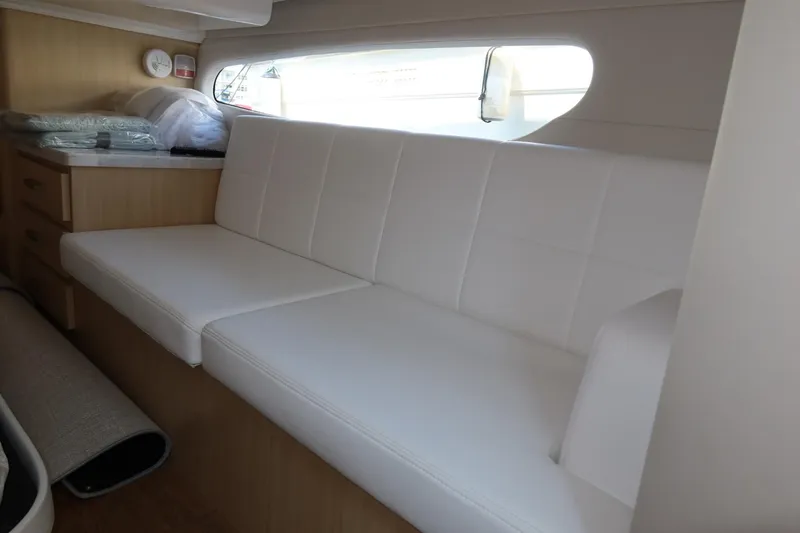 Slide: The Image of Interior of 2024 Regal 38 Fly yacht with white seating and wooden cabinetry. - 19
