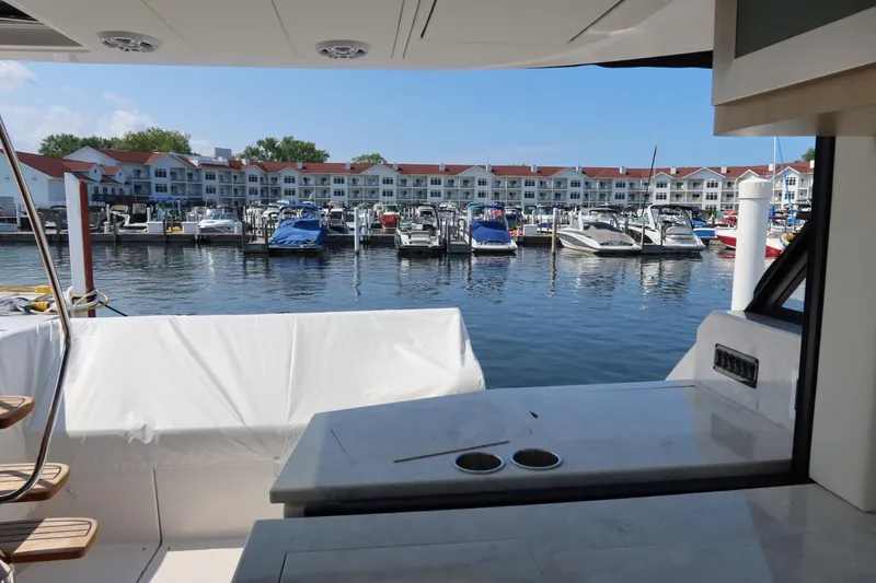 Slide: The Image of 2024 Regal 38 Fly yacht docked at marina with waterfront view. - 7