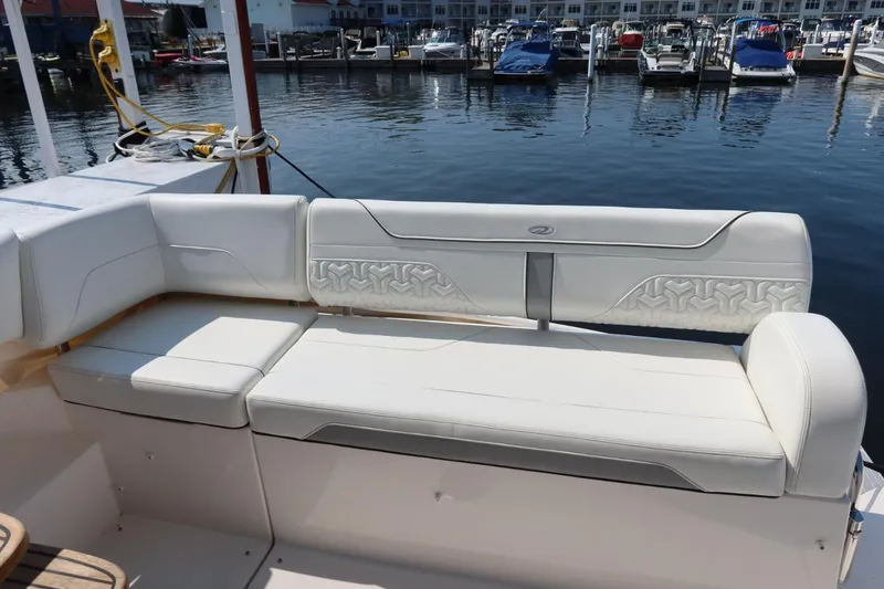 Slide: The Image of 2024 Regal 38 Fly yacht with white seating at a marina. - 8