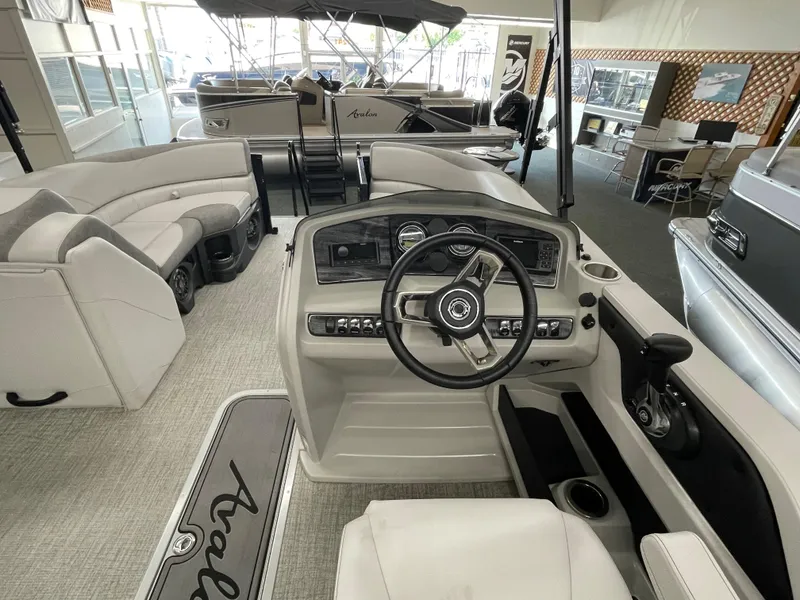 Slide: The Image of 2024 Avalon 2385 LSZ QL boat interior with steering console and seating. - 3