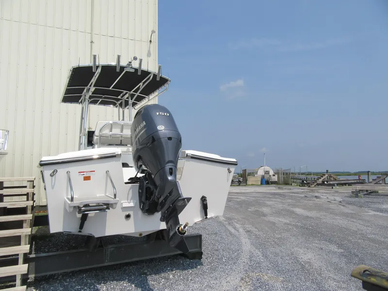 Slide: The Image of 2024 Parker 2100 Special Edition boat with outboard motor in a marina. - 11