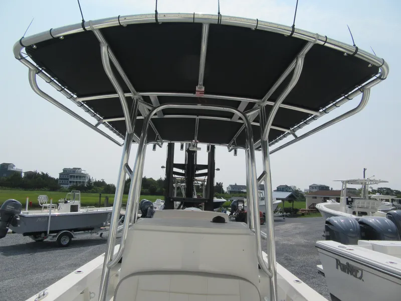 Slide: The Image of 2024 Parker 2100 Special Edition boat with T-top and dual outboard motors. - 7