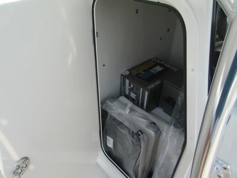 Slide: The Image of Storage compartment of 2024 Parker 2100 Special Edition boat with Garmin equipment. - 9
