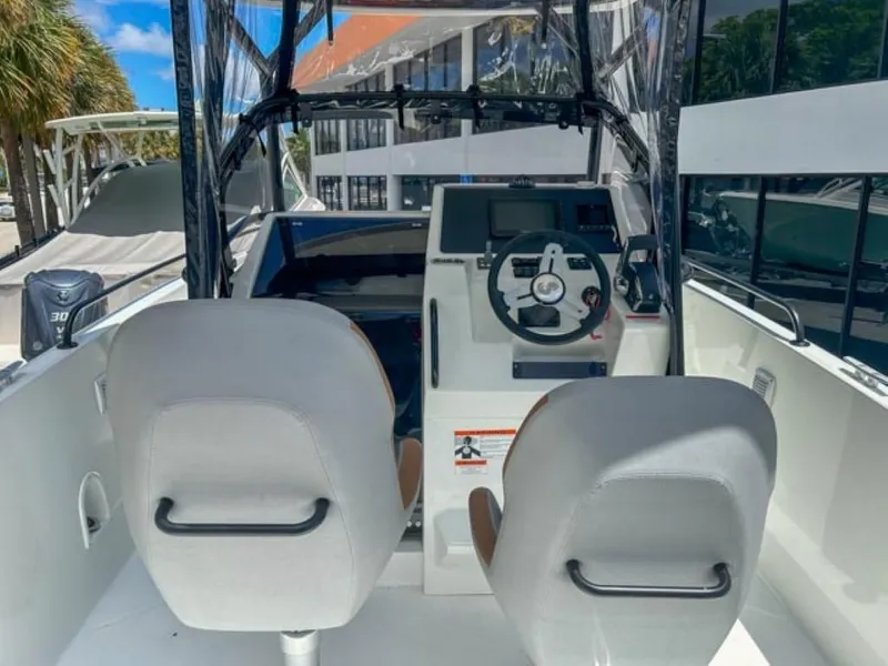 Slide: The Image of 2024 Beneteau Flyer 8 SPACEdeck cockpit with dual seats and modern steering console. - 6