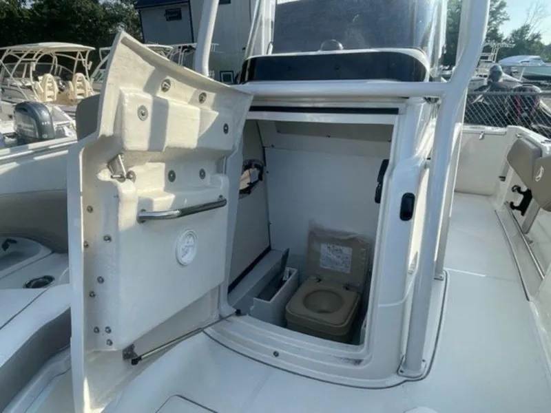 Slide: The Image of 2024 Finseeker 210 FS boat with open storage compartment and portable toilet. - 9