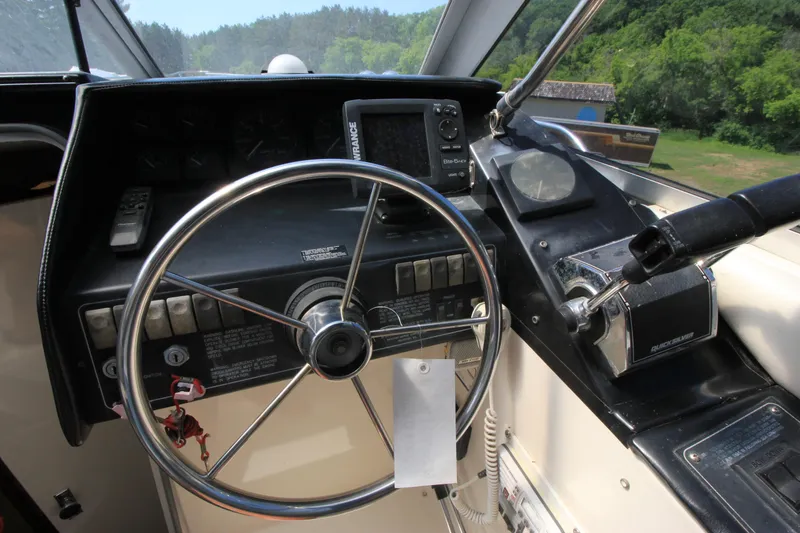 Slide: The Image of 1994 Bayliner 3055 Sunbridge helm with steering wheel and control panel. - 12