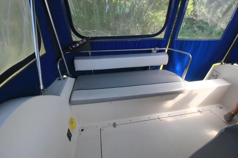 Slide: The Image of 1994 Bayliner 3055 Sunbridge interior seating area with blue canopy. - 14