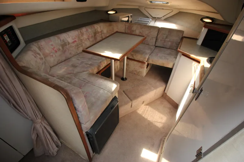 Slide: The Image of 1994 Bayliner 3055 Sunbridge cabin interior with L-shaped seating and dining table. - 16