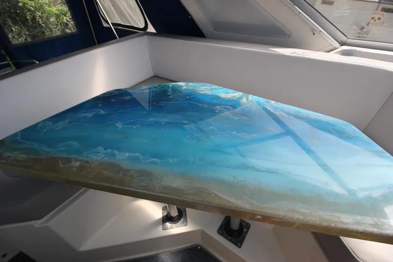 Slide: The Image of Interior of 1994 Bayliner 3055 Sunbridge with a blue resin table. - 24