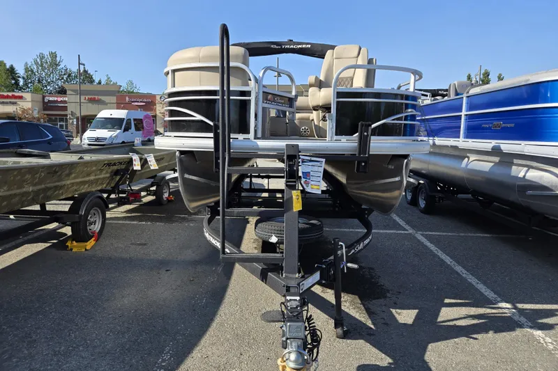 Slide: The Image of 2023 Sun Tracker SportFish 20 DLX pontoon boat on trailer in parking lot. - 3