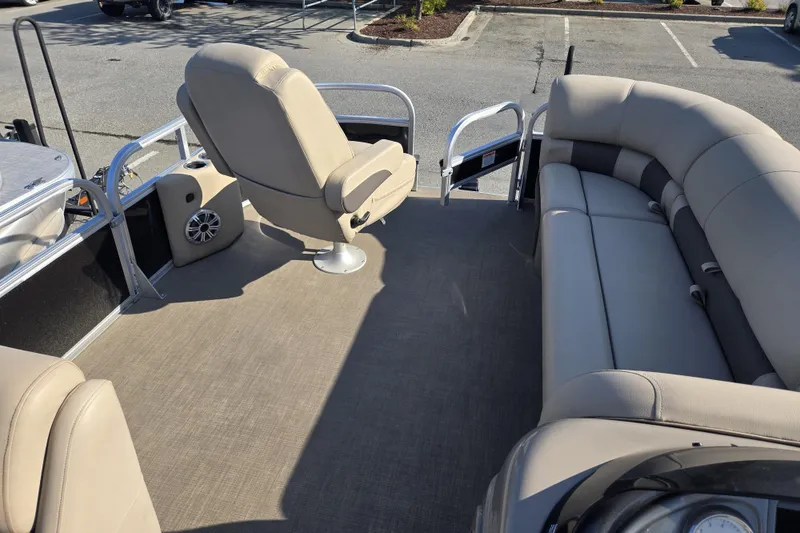 Slide: The Image of 2023 Sun Tracker SportFish 20 DLX pontoon boat interior with beige seating and spacious layout. - 10