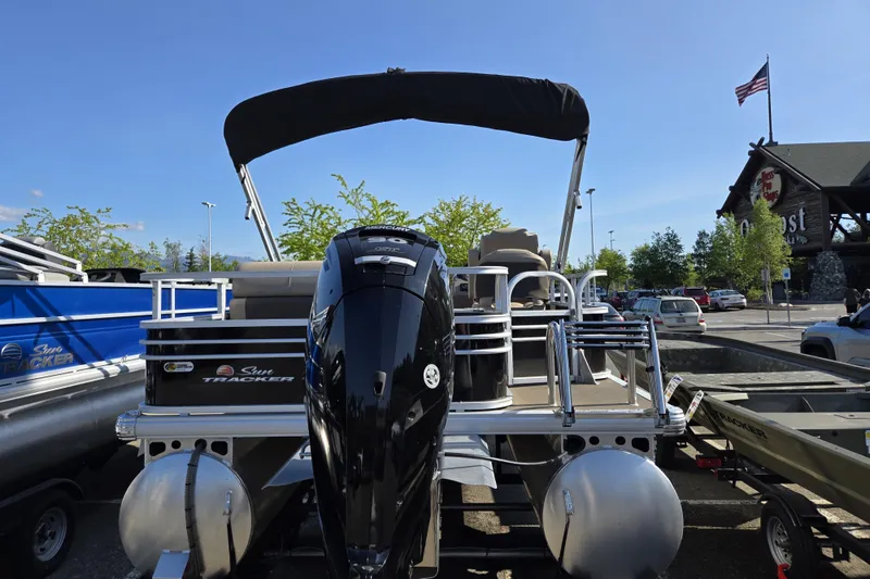 Slide: The Image of 2023 Sun Tracker SportFish 20 DLX pontoon boat with Mercury engine in a parking lot. - 7
