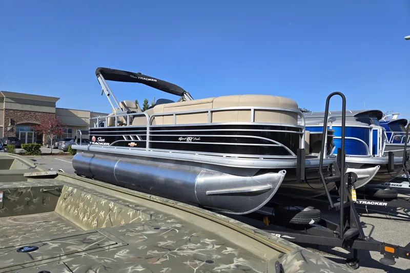 Slide: The Image of 2023 Sun Tracker SportFish 20 DLX pontoon boat displayed outdoors on a sunny day. - 4