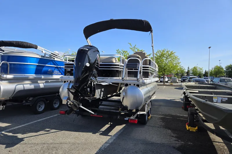 Slide: The Image of 2023 Sun Tracker SportFish 20 DLX pontoon boat in parking lot, rear view. - 6