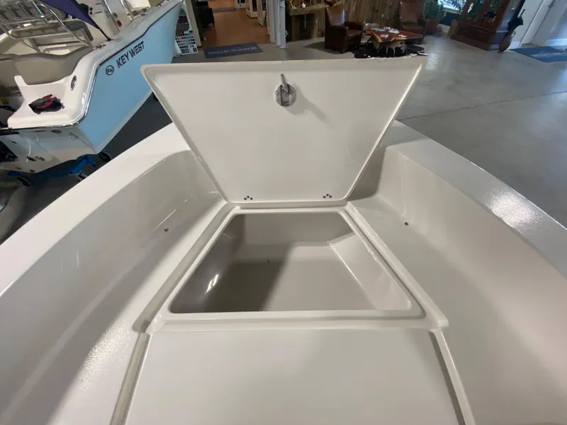Slide: The Image of 2024 Key West 179 FS boat with open storage compartment. - 13
