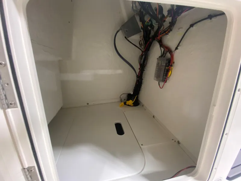 Slide: The Image of 2024 Key West 179 FS boat storage compartment with wiring. - 16
