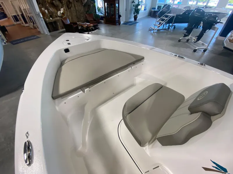Slide: The Image of 2024 Key West 179 FS boat interior with cushioned seating in showroom. - 11
