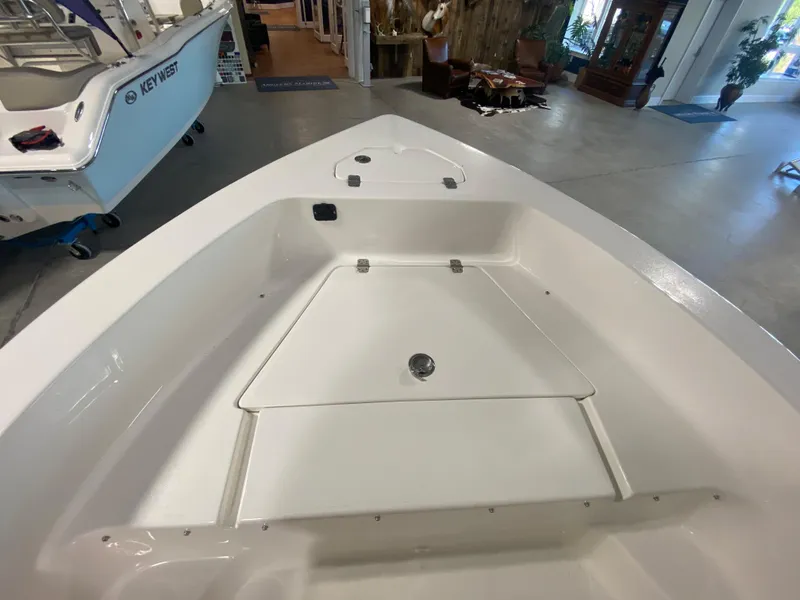 Slide: The Image of 2024 Key West 179 FS boat interior, showcasing spacious deck and storage compartments. - 12