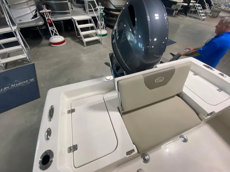 Slide: The Image of 2024 Key West 179 FS boat interior with engine and seating. - 7