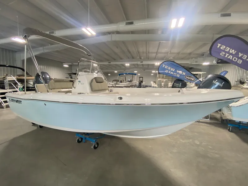 Slide: The Image of 2024 Key West 179 FS boat displayed in a showroom. - 2
