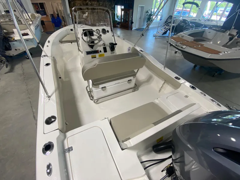 Slide: The Image of 2024 Key West 179 FS boat interior with console and seating in showroom. - 5