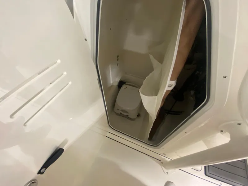 Slide: The Image of 2024 Key West 244 CC boat interior with built-in toilet. - 14