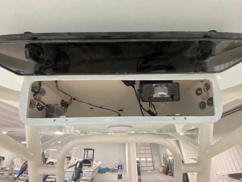 Slide: The Image of 2024 Key West 244 CC center console electronics compartment in a boat showroom. - 17