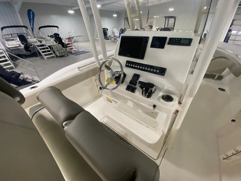 Slide: The Image of 2024 Key West 244 CC boat console with steering wheel and electronic controls. - 11