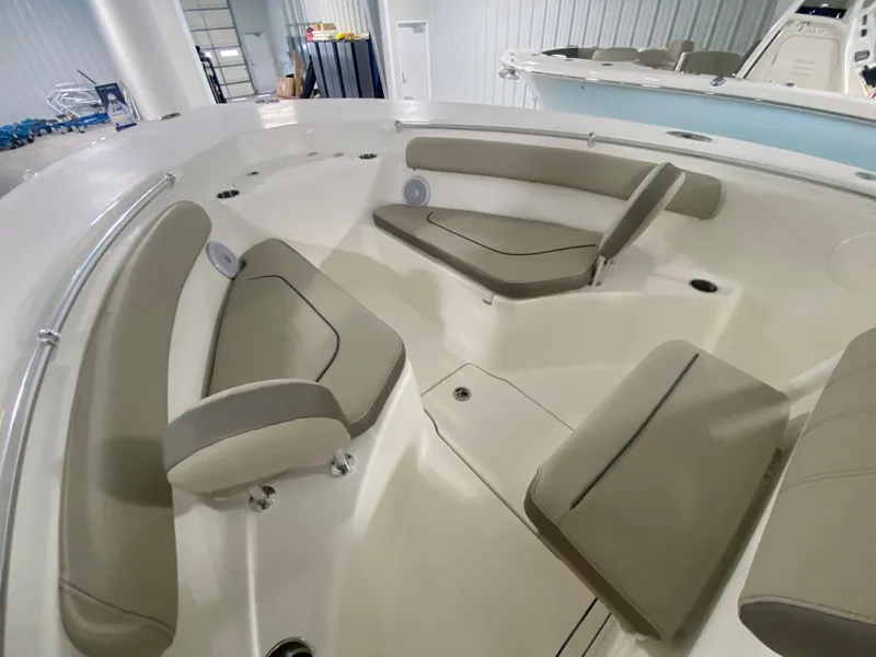 Slide: The Image of 2024 Key West 244 CC boat interior with beige seating in a showroom. - 15