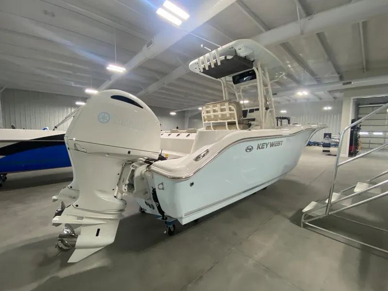 Slide: The Image of 2024 Key West 244 CC boat in showroom, rear view with outboard motor. - 3