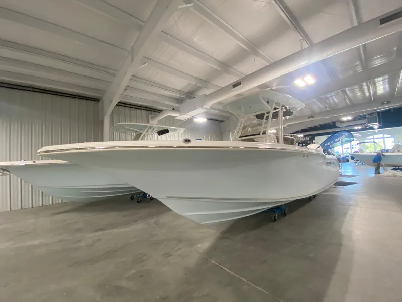 Slide: The Image of 2024 Key West 244 CC boat in showroom, side view. - 1