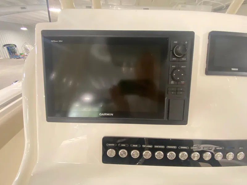 Slide: The Image of 2024 Key West 244 CC boat dashboard with Garmin GPS and control panel. - 12