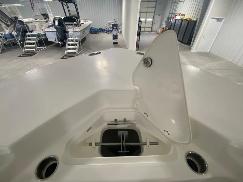 Slide: The Image of 2024 Key West 244 CC boat anchor storage compartment in a showroom. - 19