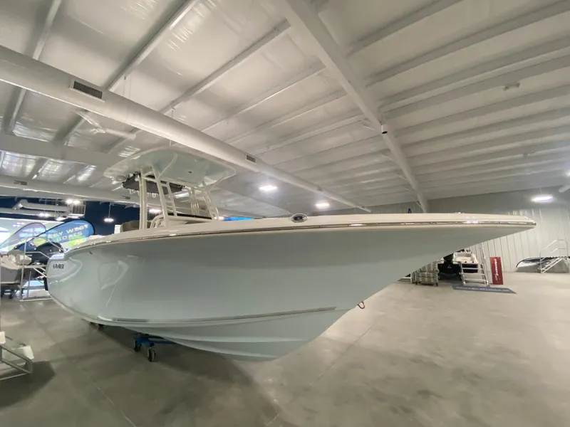 Slide: The Image of 2024 Key West 244 CC boat displayed in a showroom. - 2