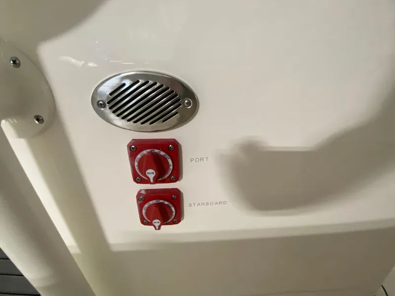 Slide: The Image of Key West 244 CC 2024 boat control panel with port and starboard switches. - 24