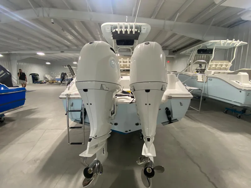 Slide: The Image of 2024 Key West 244 CC boat with twin outboard engines in a showroom. - 4