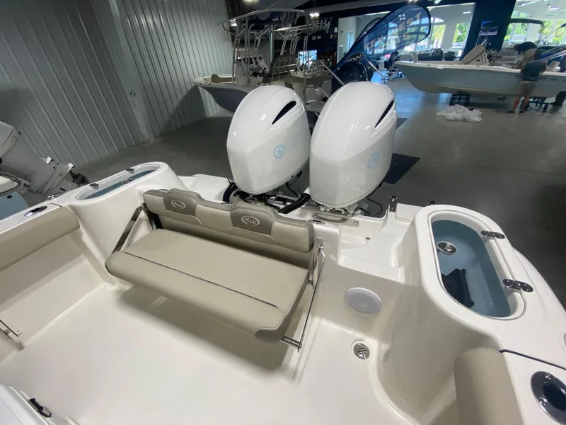Slide: The Image of 2024 Key West 244 CC boat interior with twin outboard engines in showroom. - 7
